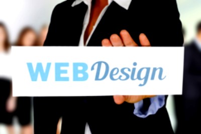 Person holding Web Design sign